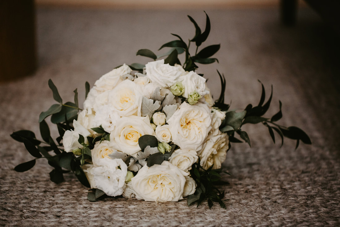 Wedding bouquet of cream Amy Lou roses, lisianthus, silver suede and Italian ruscus. 