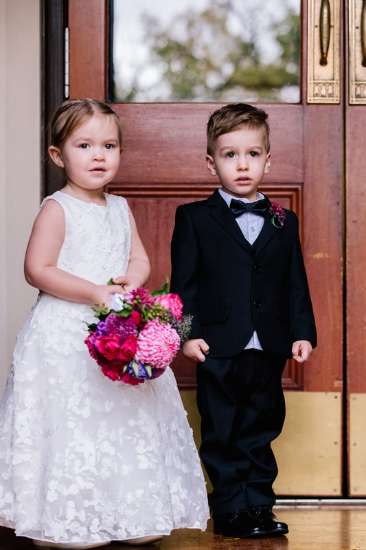 Flower girl and page boy with bright jewel toned posy and buttonhole. 