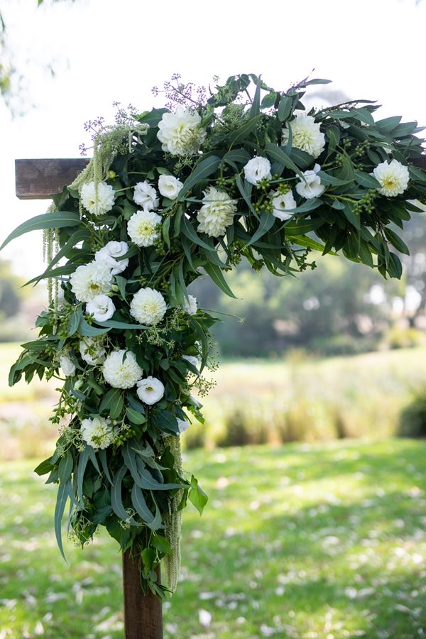 Rustic wedding arbour, wood arbour with white and green flowers, eucalyptus, dahlias, roses