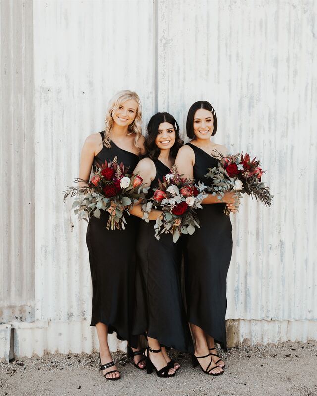 Bridesmaids at Marnong Estate in Mickelham holding rustic flower bouquets of proteas and roses