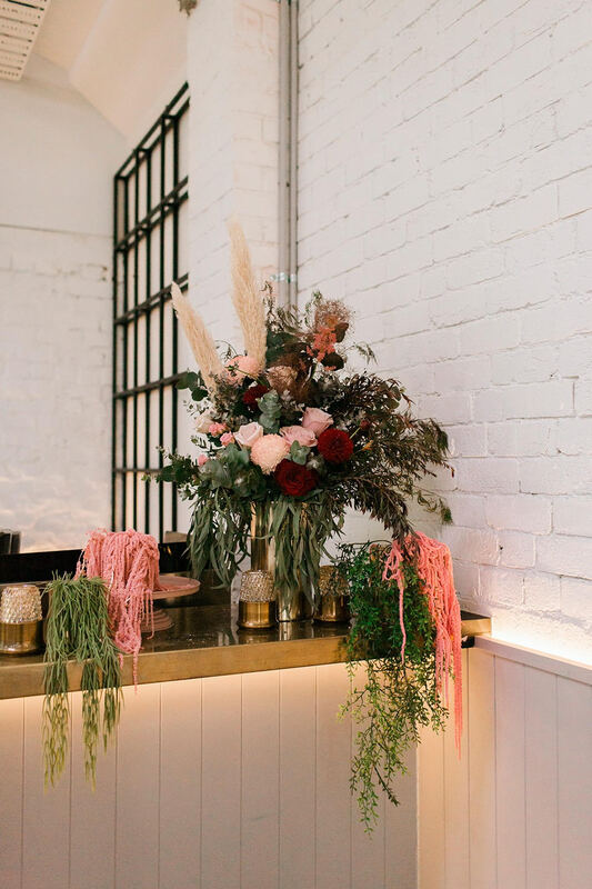 Bar arrangement at Canvas House, South Melbourne, featuring pampas grass, roses and eucalyptus.  