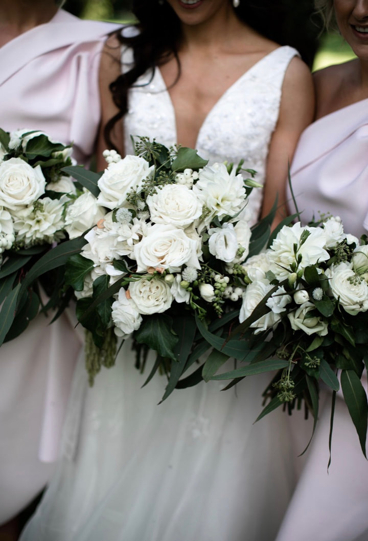 Wedding flower bouquets of white roses, dahlias and eucalyptus
