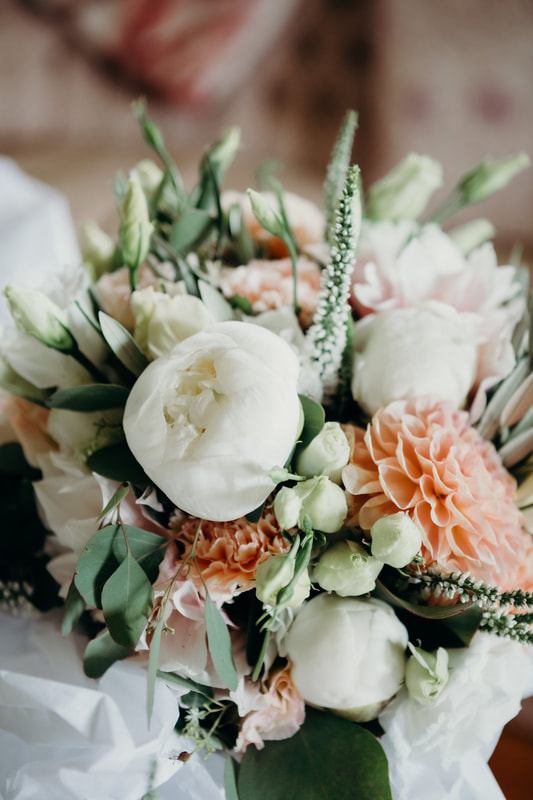 Bridal bouquet featuring peonies, dahlias and veronica in white, peach and silver colour palette
