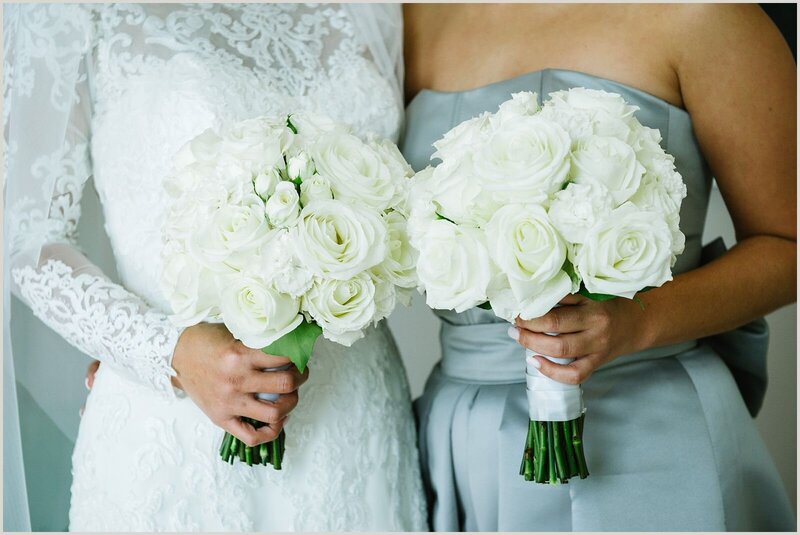 Round classic wedding bouquets of white roses, spray roses and carnations. 