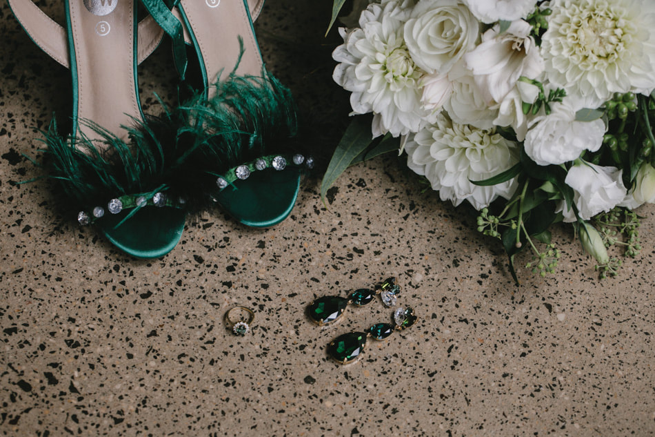 Wedding flower bouquet of white and green roses, dahlias and eucalyptus, emerald green wedding accessories, shoes and earrings