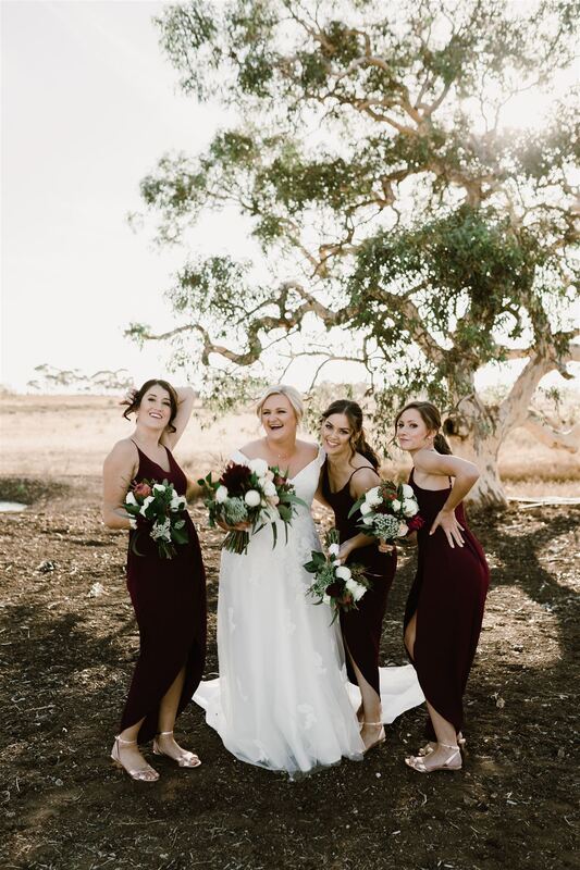 Bride and her bridesmaids holding wedding bouquets at Russo Estate