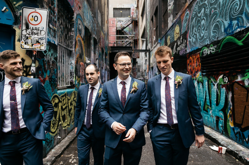 Groom and his groomsmen in Melbourne's graffiti laneways with rustic native flower buttonholes