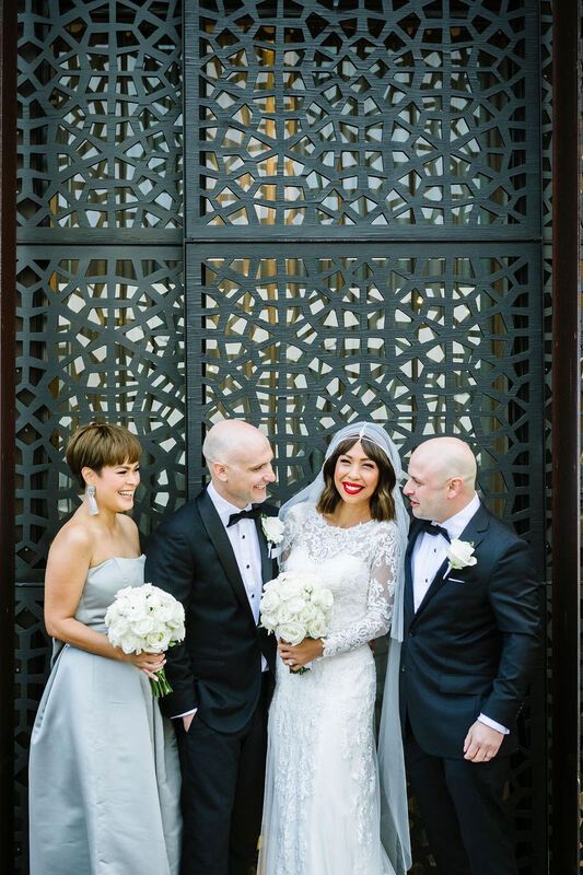 Modern elegant bridal party at The Prince in St Kilda with white rose bouquets and buttonholes. 
