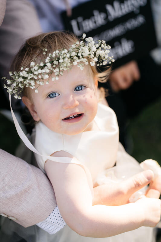 Flower girl with floral crown made of babies breath. 