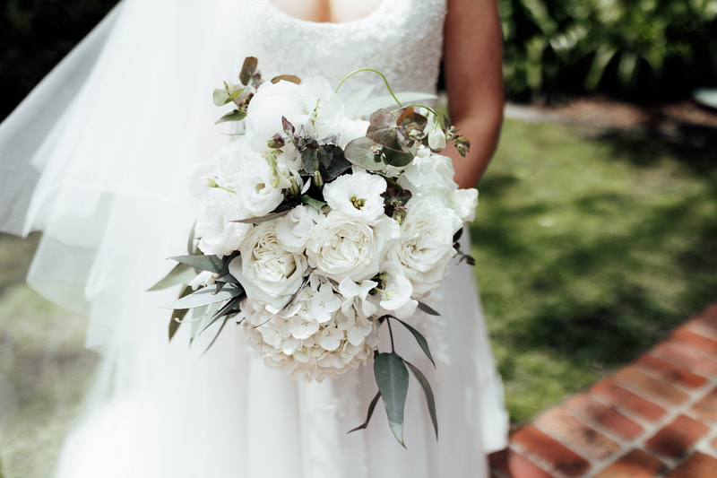 Wedding flower bouquet of white roses, hydrangea, lisianthus and eucalyptus leaves. 